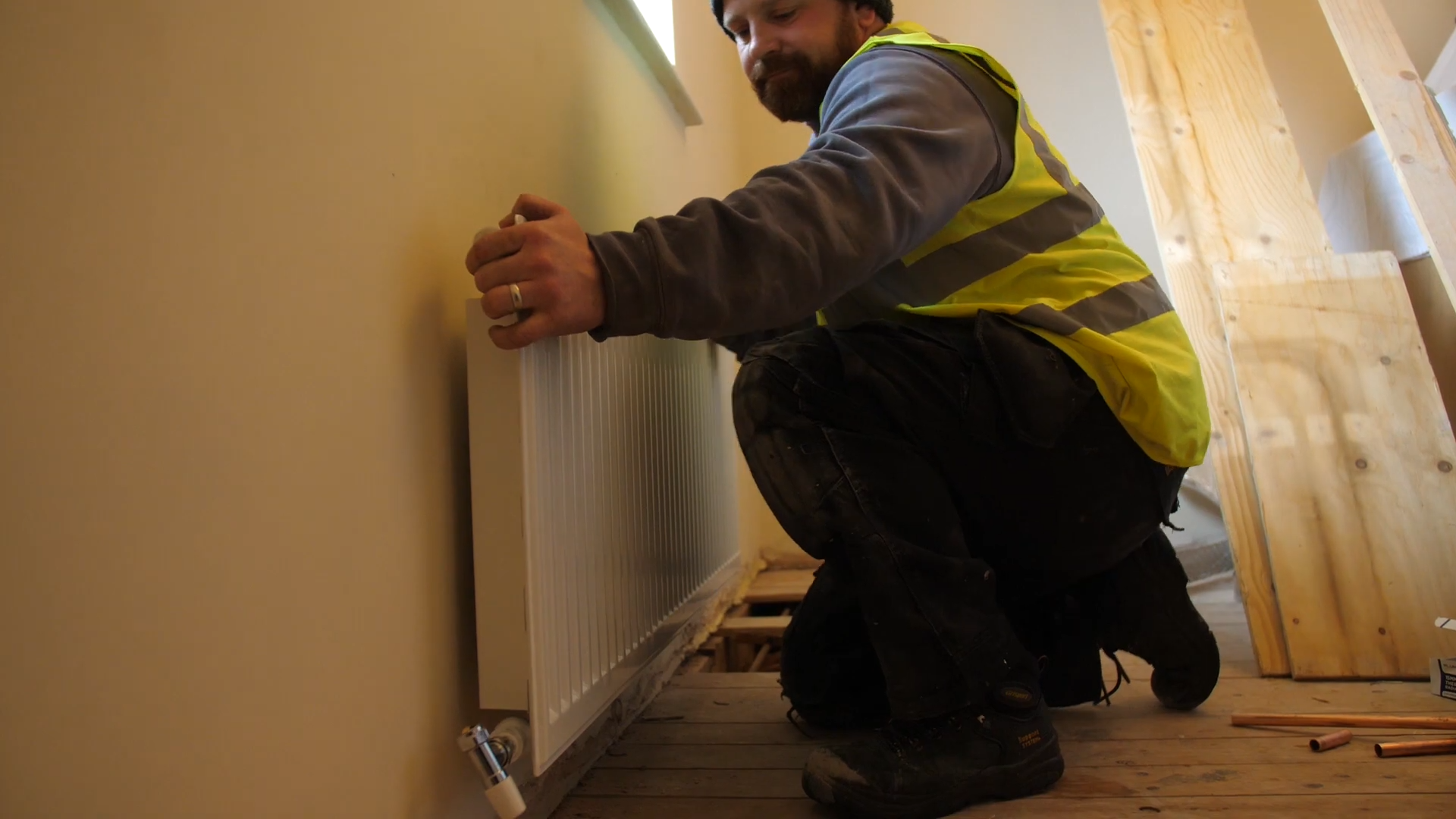 Image of Greenview staff member fitting radiator