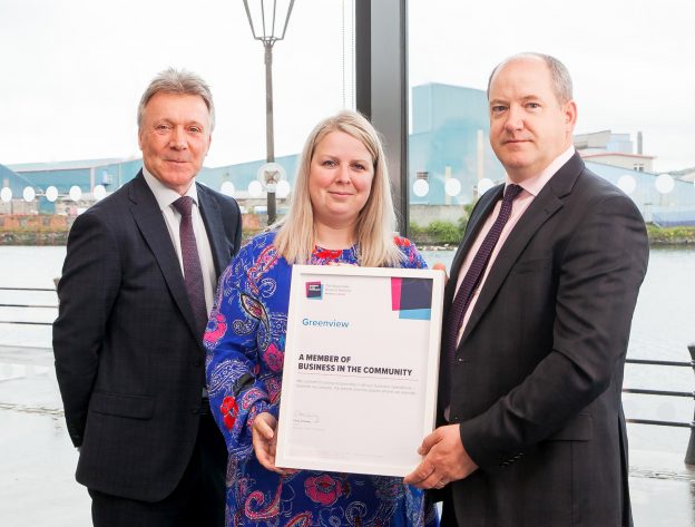 Image of Kieran Harding, Managing Director of Business in the Community NI, with Tanya Fisher and Roy Connolly from Greenview, holding a framed certificate for Greenview joining Business in the Community NI.
