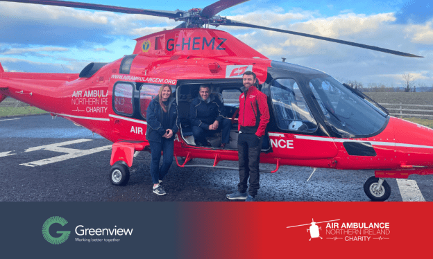 Image of Greenview members of staff alongside a HENI Paramedic, in front of the Air Ambulance Northern Ireland helicopter